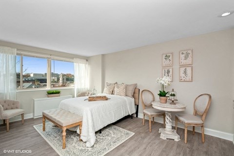 a bedroom with a large bed and a large window