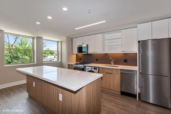 a kitchen with an island and stainless steel appliances at Carver and Slowe Apartments, Washington, Washington, DC 20001
