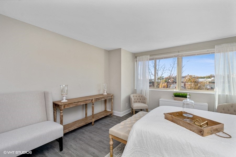 a bedroom with a bed sitting next to a window