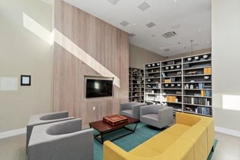 library lounge showing tv, club chairs, and sofa at Carver and Slowe Apartments, Washington, Washington, DC 20001