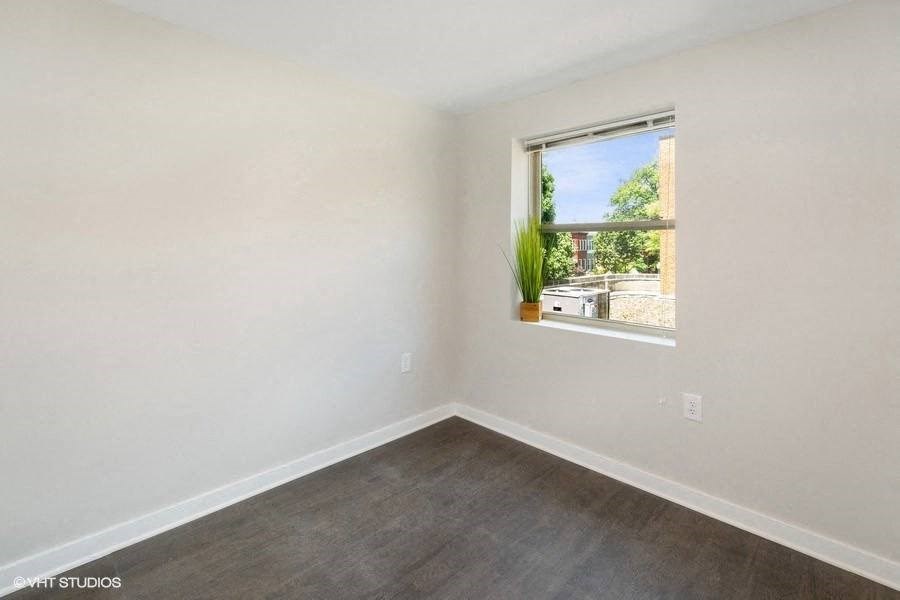 an empty room with a window and a plant at Carver and Slowe Apartments, Washington, Washington, DC 20001
