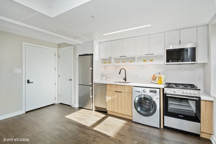 a kitchen with white cabinetry and stainless steel appliances at Carver and Slowe Apartments, Washington, Washington, DC 20001