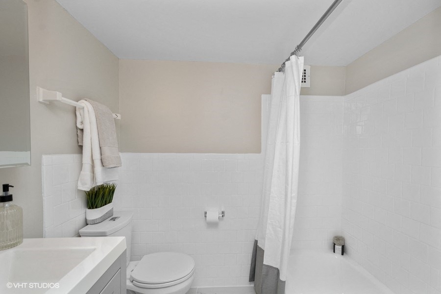 a bathroom with a toilet sink and bathtub