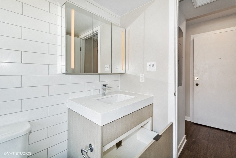 a bathroom with a sink and a mirror at Carver and Slowe Apartments, Washington