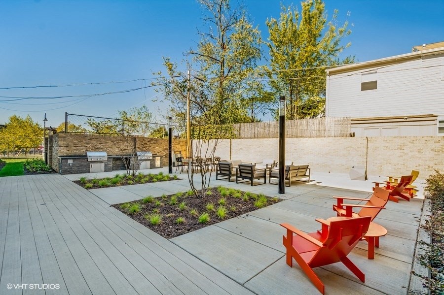 a backyard with a wooden deck and a fire pit at Carver and Slowe Apartments, Washington, DC, 20001