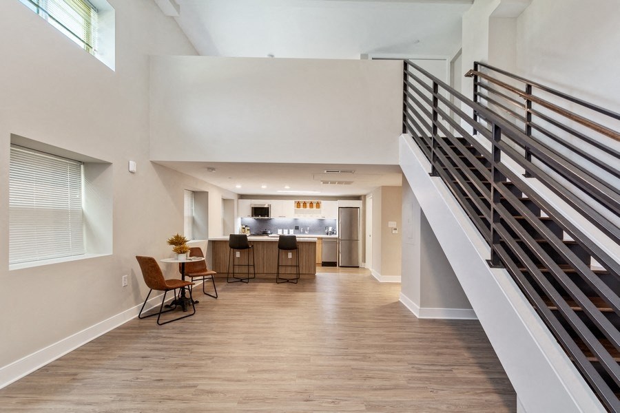 a spacious living room with a staircase leading up to the second floor at Carver and Slowe Apartments, Washington, DC