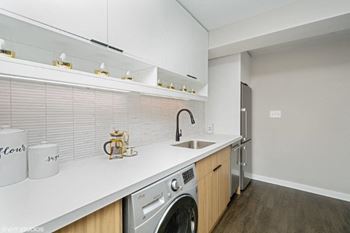 a laundry room with a washer and a sink at Carver and Slowe Apartments, Washington, DC, 20001