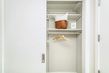 a closet with shelves and a basket in it