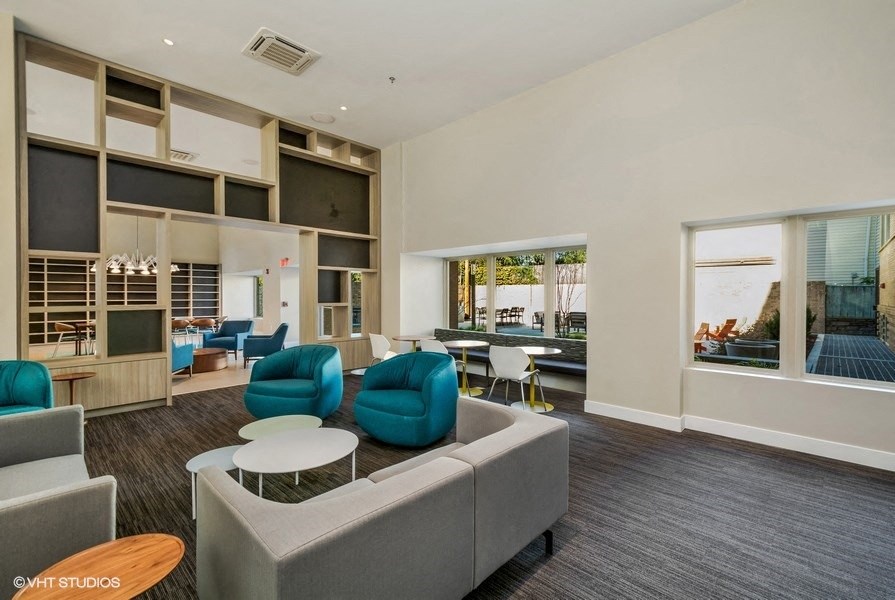 a living room with a couch chairs and tables at Carver and Slowe Apartments, Washington, DC