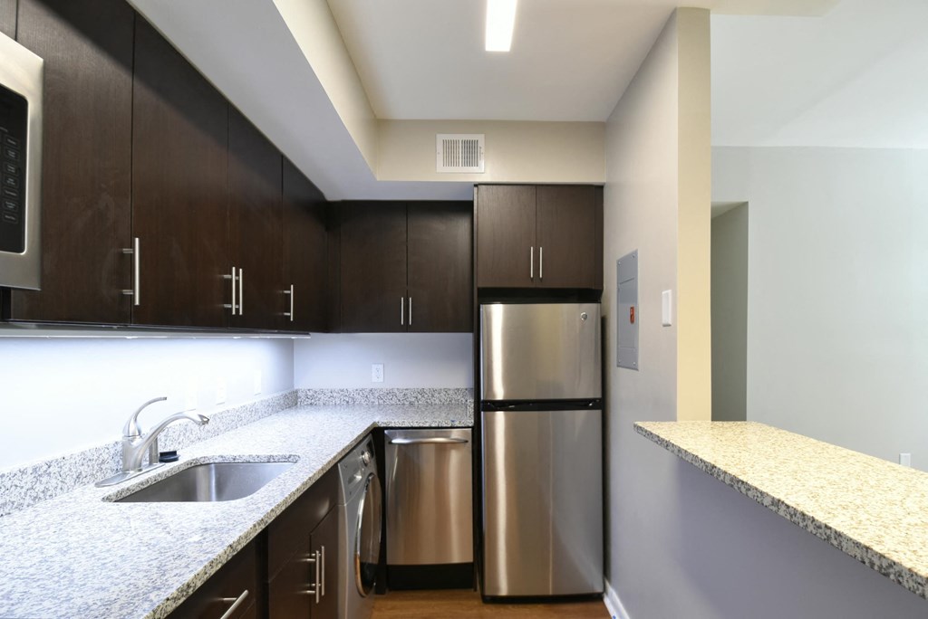 a kitchen with granite countertops and stainless steel appliances