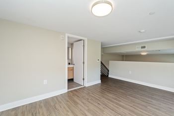 a bedroom with hardwood floors and white walls at Carver and Slowe Apartments, Washington, 20001