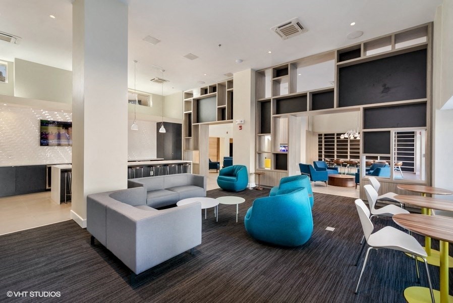 a room with couches chairs and tables at Carver and Slowe Apartments, Washington, DC
