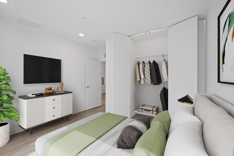 A living room with a white couch and a green cushion.