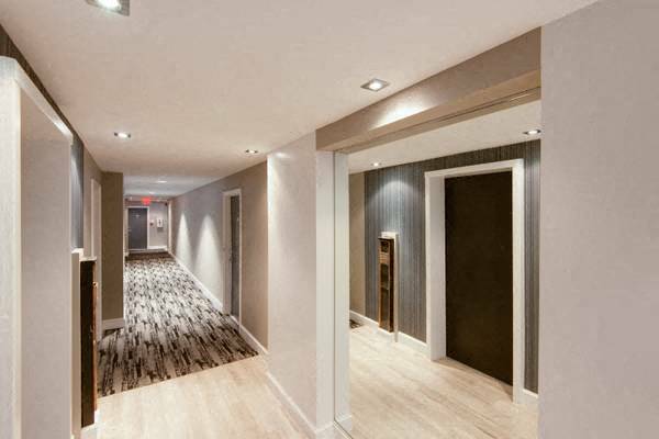 a hallway with white walls and a wooden floor