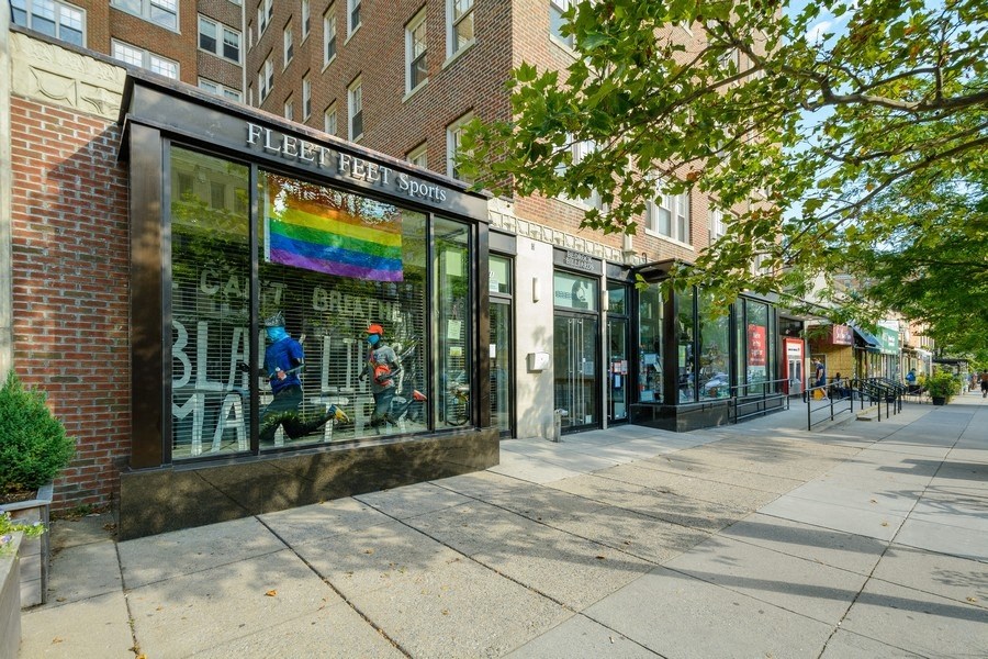a store front with a rainbow sign in the window