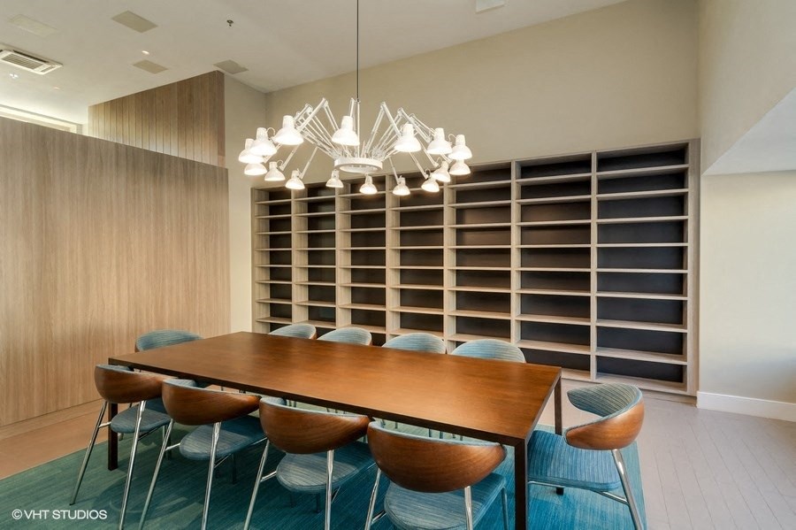 Conference Room with a long wooden table and blue chairs at Carver and Slowe Apartments, Washington Washington, DC