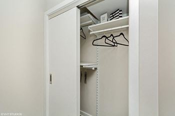 a closet with a white door and a white shelf with glasses on it at Carver and Slowe Apartments, Washington, DC