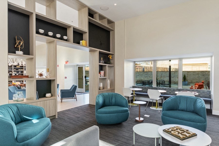 a living room filled with furniture and a large window at Carver and Slowe Apartments, Washington