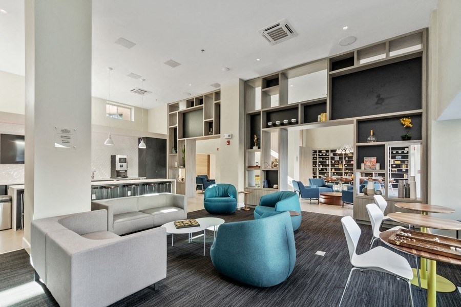 a lobby with couches chairs and tables at Carver and Slowe Apartments, Washington Washington, DC