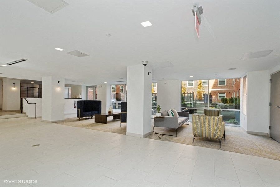 a lobby with couches and chairs and a television at Carver and Slowe Apartments, Washington Washington, DC