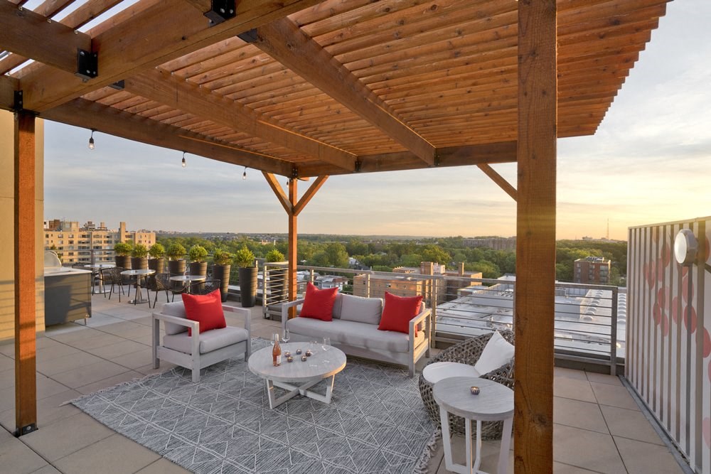 a roof deck with couches and tables