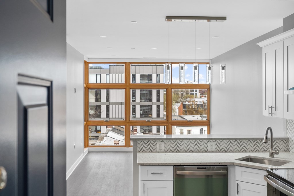 A kitchen with a large window and a sink.