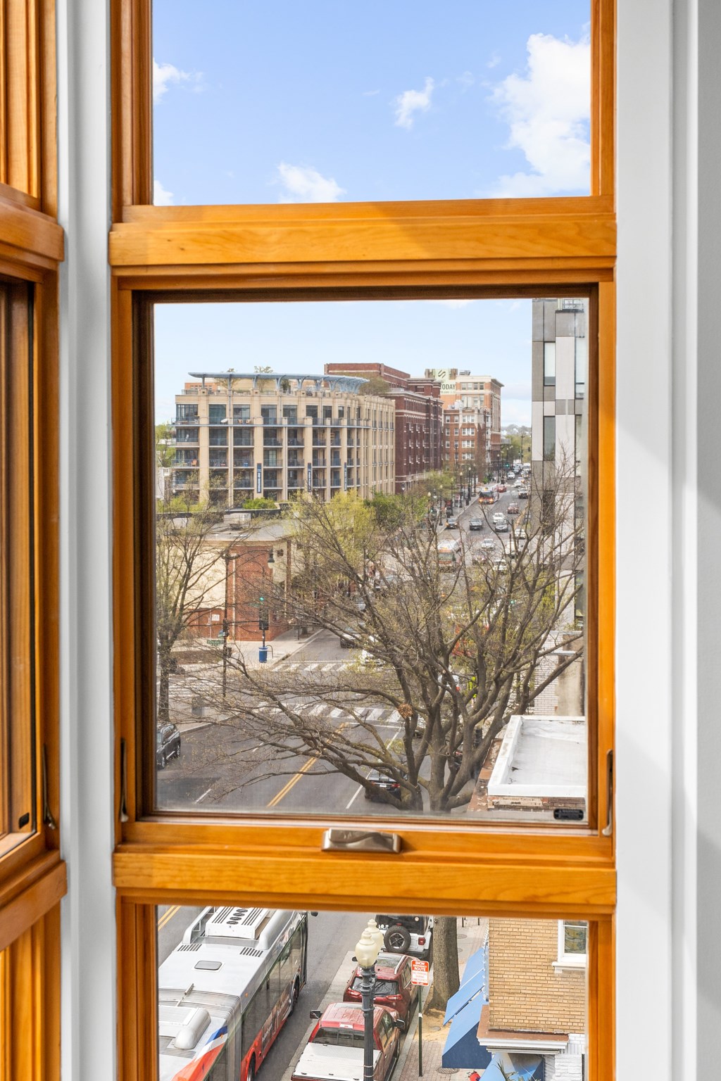 A view of a city street through a window.