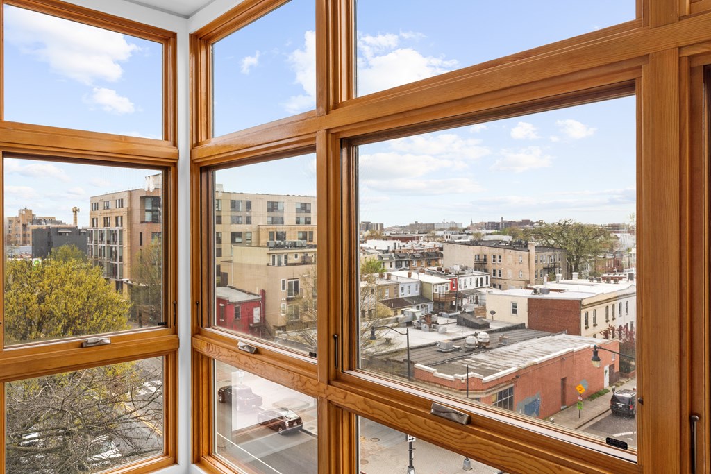 A view of a city from a window with four panes of glass.