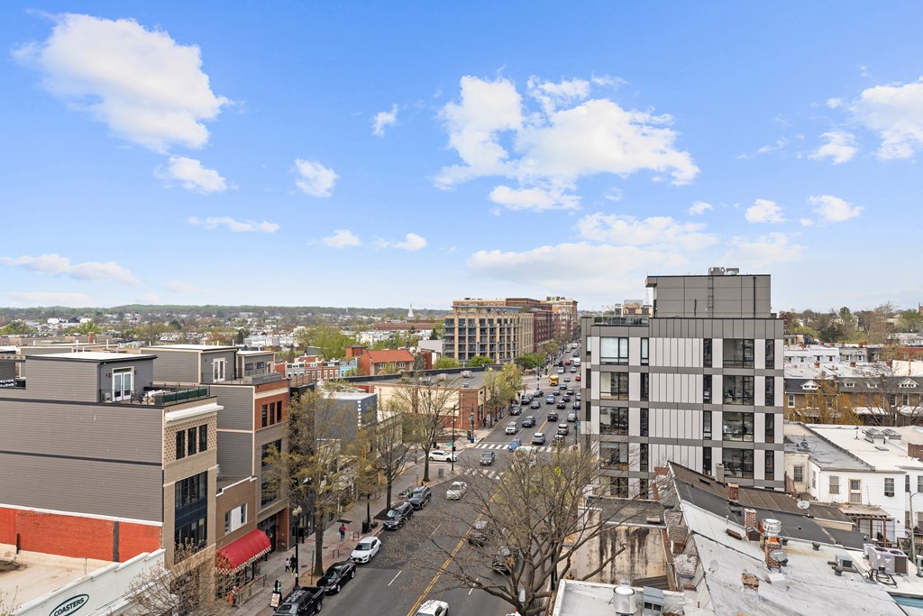 A city street with cars and buildings.