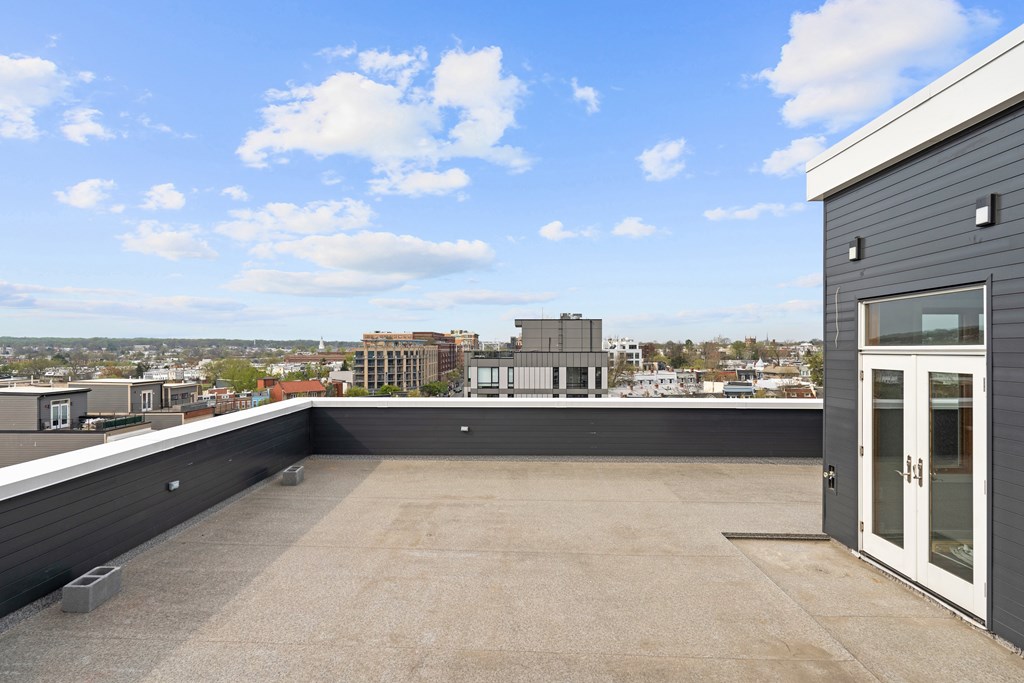 A rooftop with a building and a clear sky.