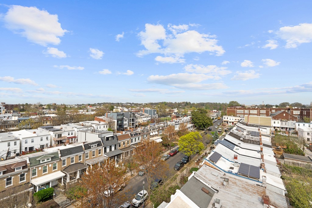 A view of a residential area with houses and cars.