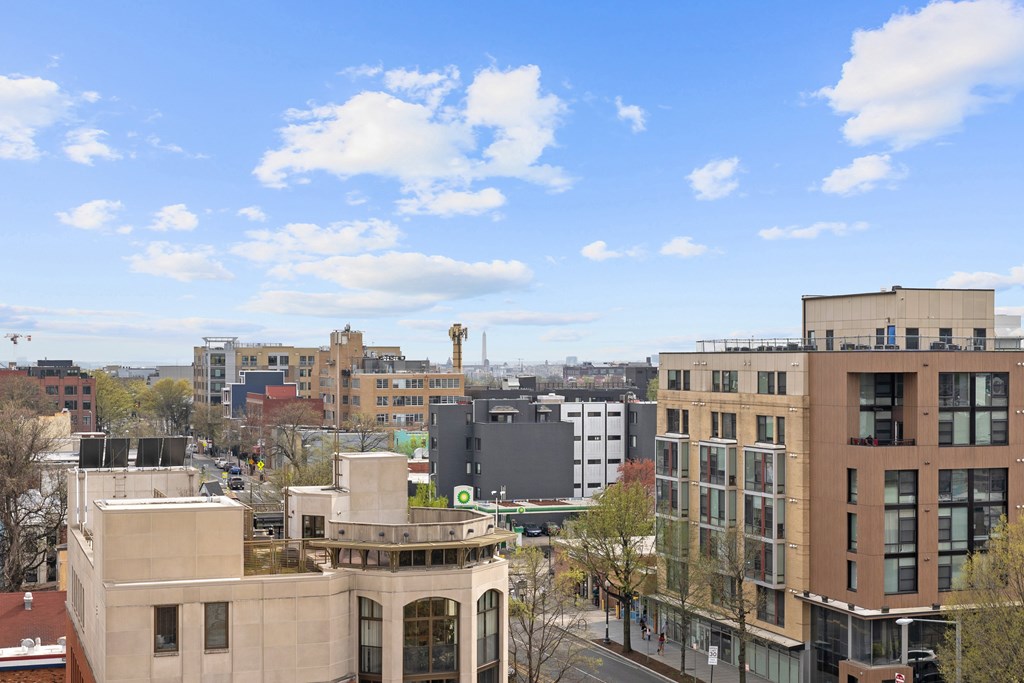 A cityscape with buildings of various designs and a clear blue sky.
