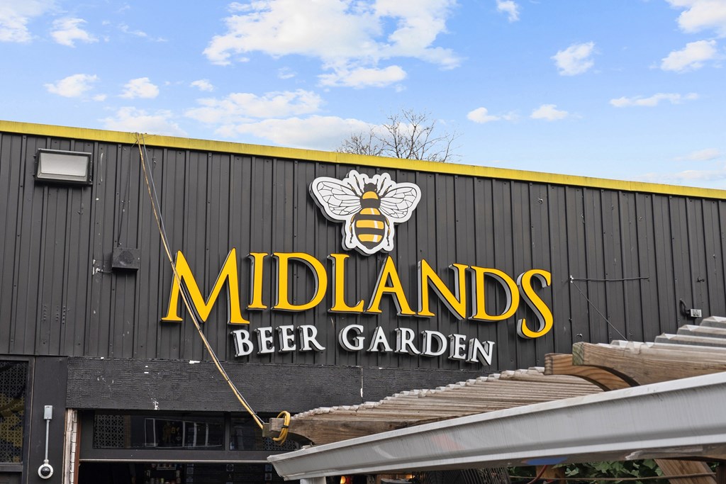 The Midlands Beer Garden sign is gold and features a bee.