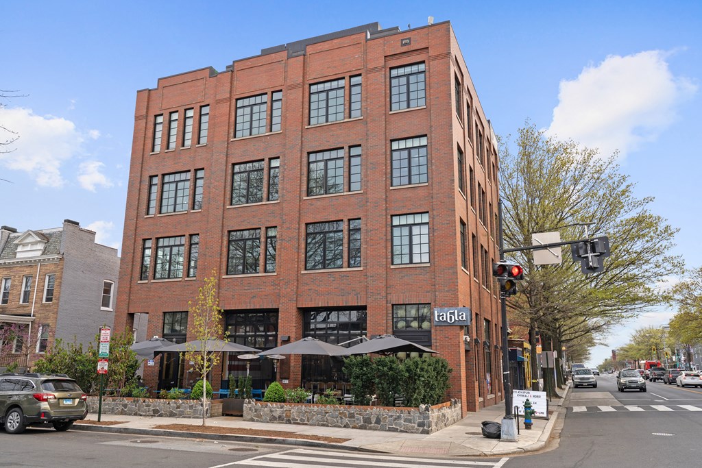 A red brick building with a black awning and the word "tapia" on the front.