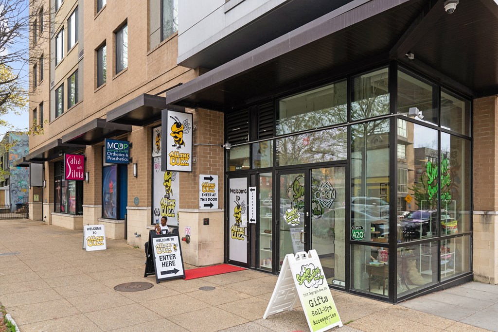 A storefront with a red carpet leading to the entrance.