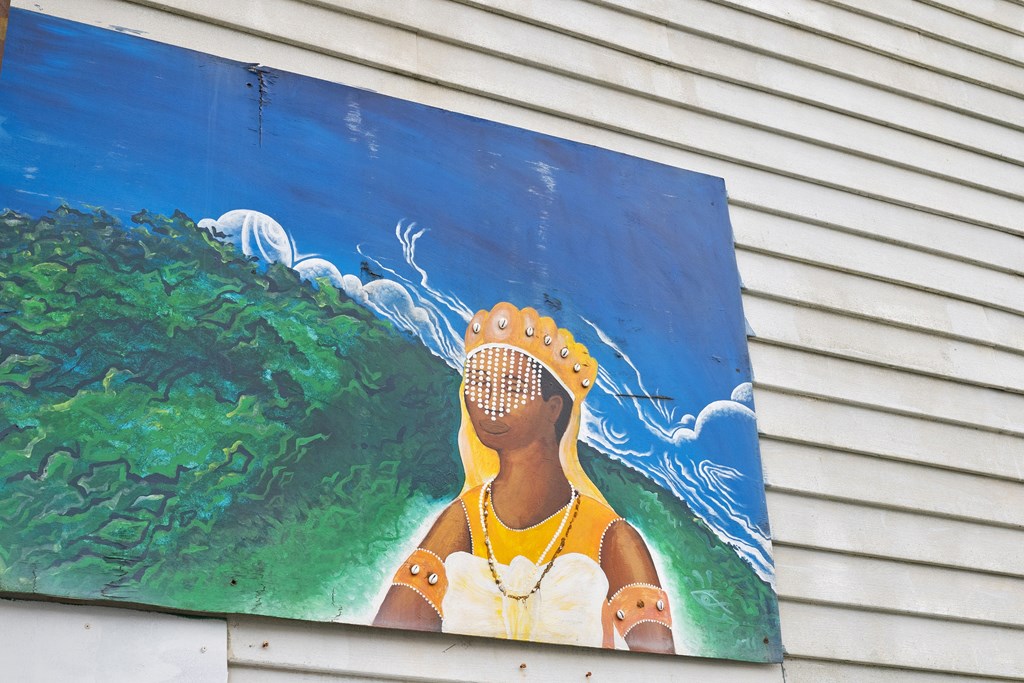 A painting of a person with a tennis racket on their head.