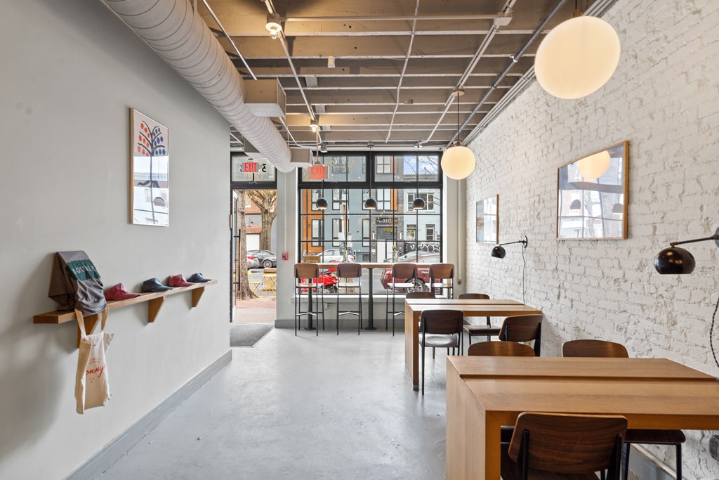 A white room with a long table and chairs.