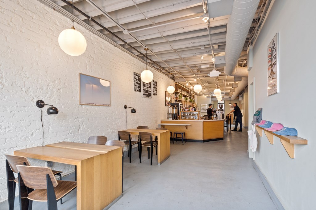 A white room with a long table and chairs.