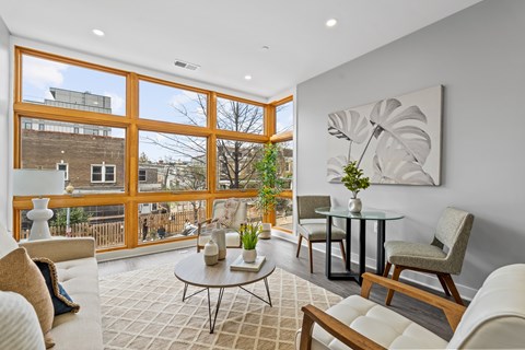 A living room with a glass table and chairs.