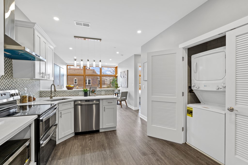 A modern kitchen with white cabinets and a large island.