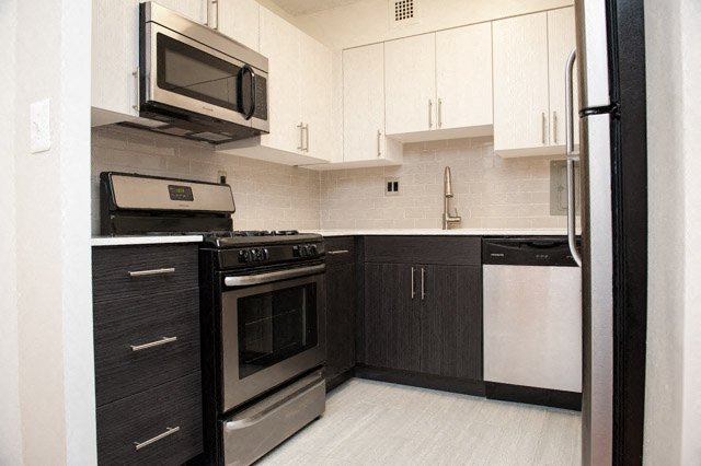 a kitchen with stainless steel appliances and white cabinets