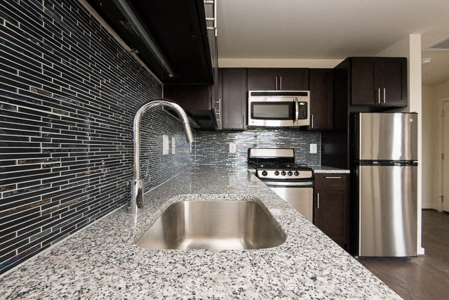 a kitchen with a sink a stove and a refrigerator