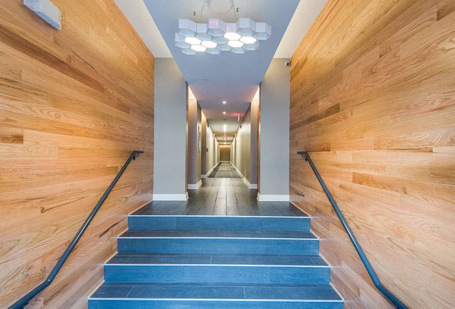 a view down a long hallway with blue stairs and wood walls a view down a long hallway with blue stairs and wood walls - Photo Gallery