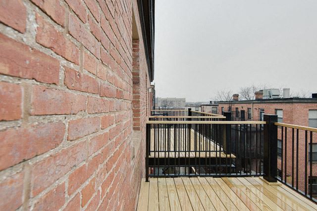 a brick wall with a wooden deck in front of it a brick wall with a wooden deck in front of it - Photo Gallery