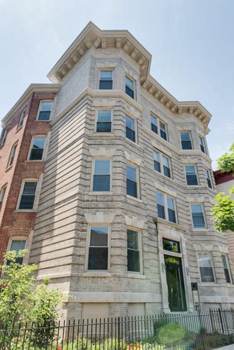 a tall building with a fence in front of it