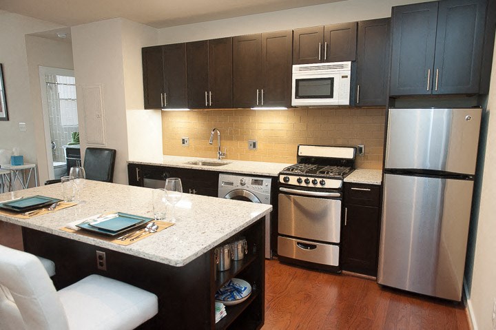 a kitchen with a stove a refrigerator and a sink