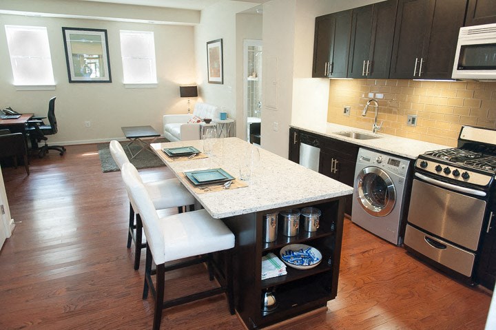 a kitchen with a counter top and a stove top oven