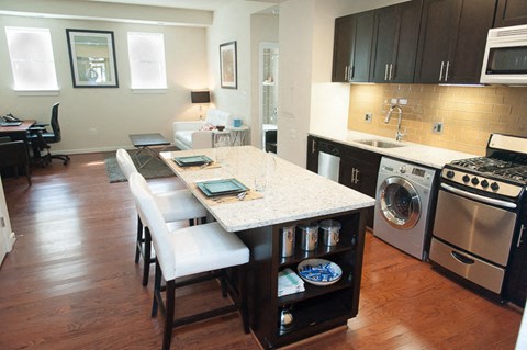 a kitchen with a counter top and a stove top oven