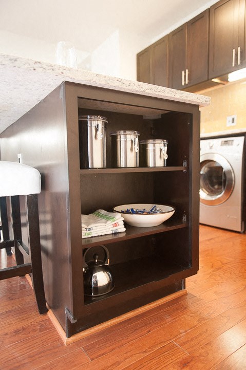 a small kitchenette with a counter and a washing machine