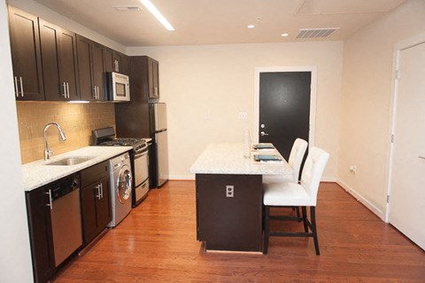 a kitchen with a stove top oven next to a sink